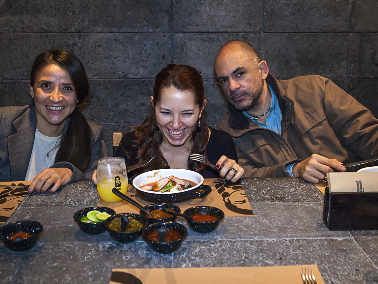 a person sitting at a table eating food