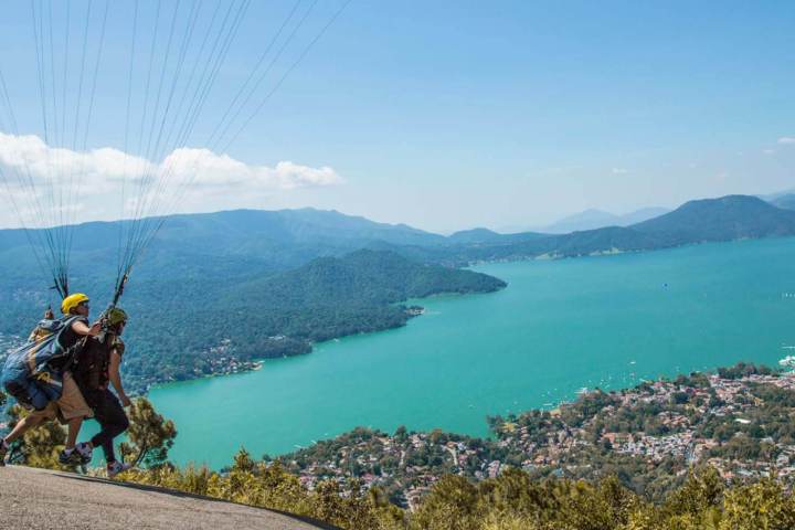 a body of water with a mountain in the background